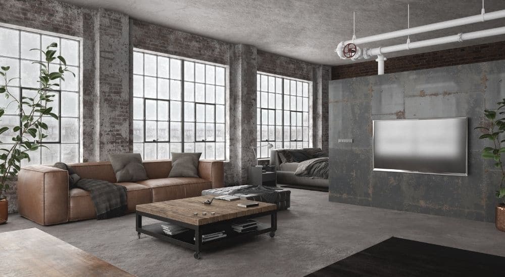 De grote stalen ramen en het moderne interieur vormen samen een mooi geheel. In elk raam is een vierkant raam geïntegreerd dat je kan openen en sluiten.