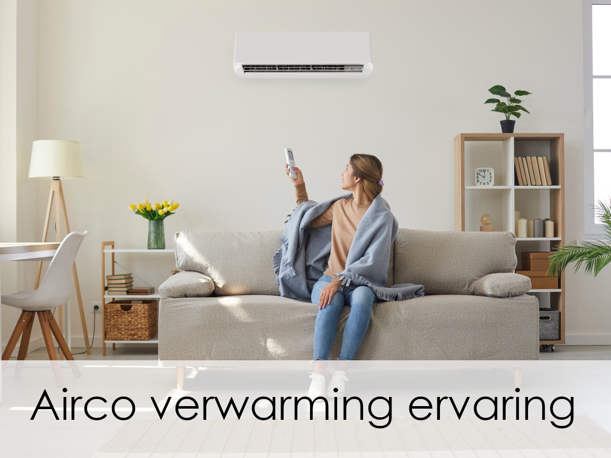 vrouw met deken op bank zet airco aan voor verwarming