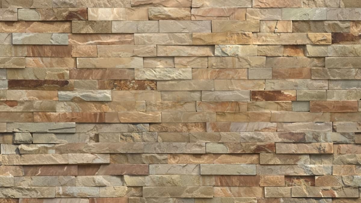 Een bakstenen gevel in een lichte kleur. De stenen hebben een onregelmatige structuur en tint.