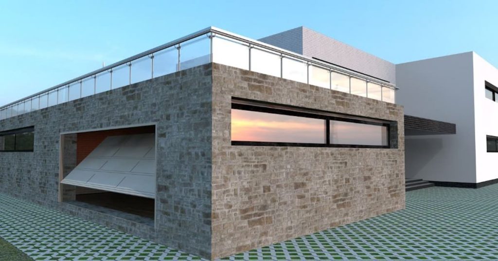 De stenen gevelbekleding van een moderne woning met garage. De stenen zijn lichtgrijs tot bruin van kleur.